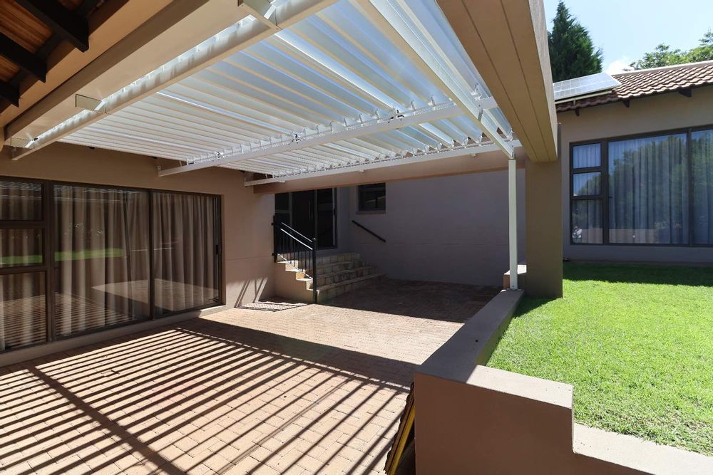 Close-up of louvre covered patio adjacent to patio with braai