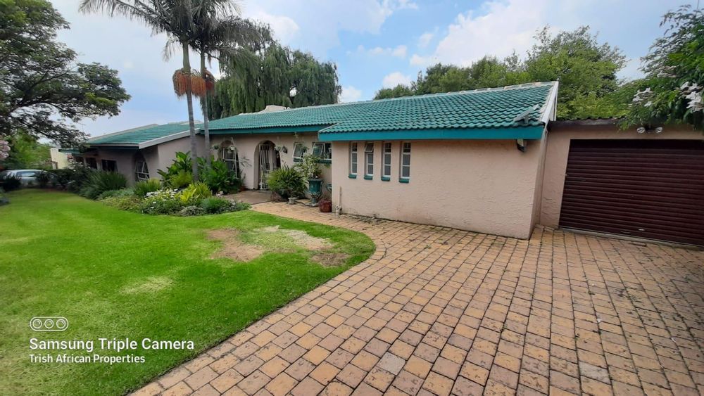 Front of house and garden with garage