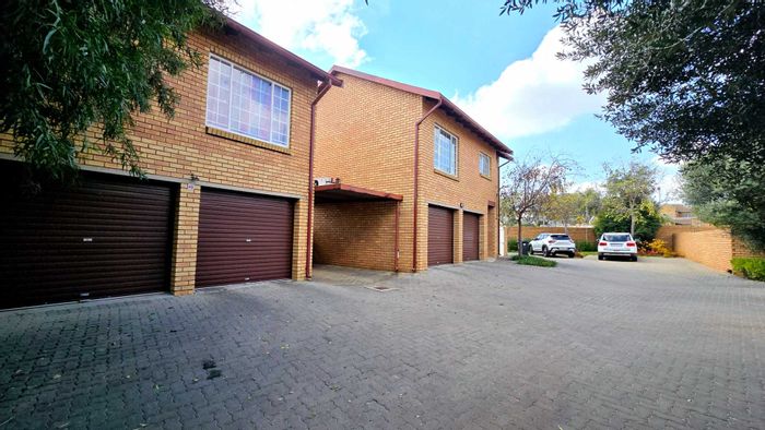 For Sale: Spacious Equestria Townhouse with 3 Bedrooms, Double Garage, and Private Garden.