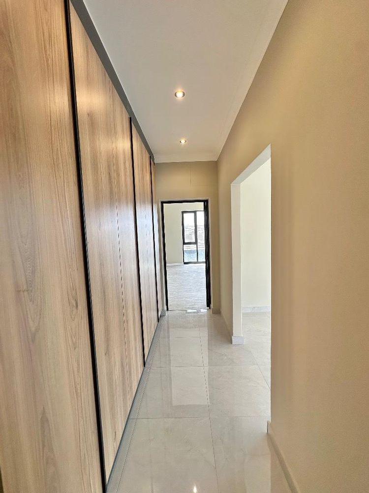 Passage way to fifth bedroom with ample cupboard space