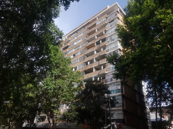 Hillbrow Apartment For Sale: One bedroom, balconies, fitted kitchen, negotiable price.