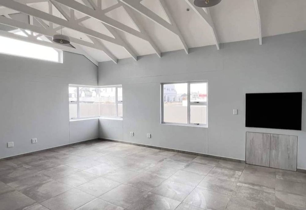 Open-plan kitchen/ lounge/dining area with indoor BBQ area