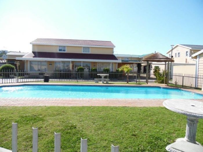 Townhouse For Sale in Hartenbos Central: Pool, secure complex, beach proximity.