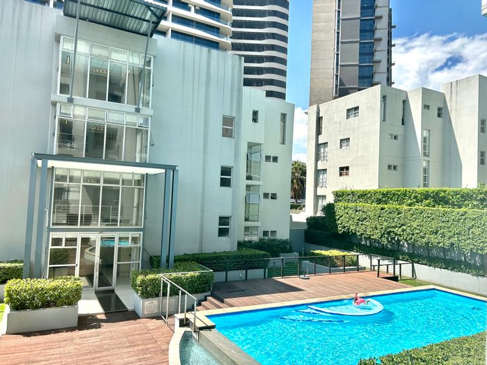 Garden apartment in Morningside: 2 beds, 2 baths, patio, secure parking. To Rent.