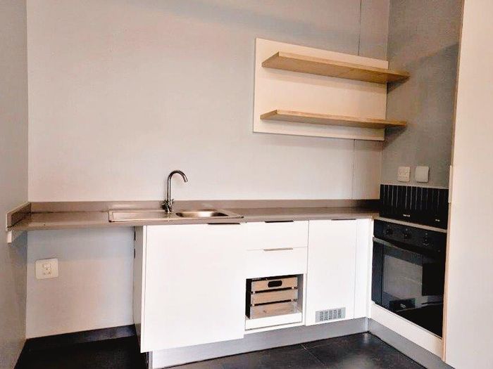 Braamfontein Werf Apartment For Sale: Studio with parking, security, and greenbelt access.