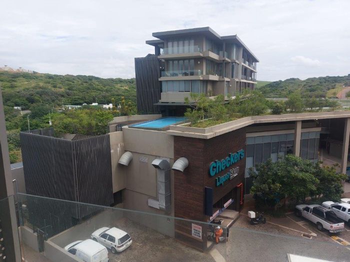 Sibaya Precinct Apartment To Rent: Open plan living, balcony, 24-hour security, pools.