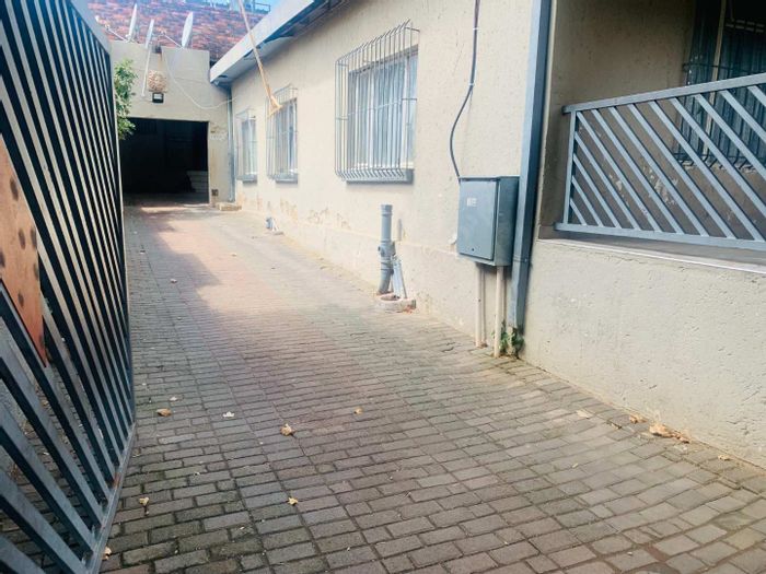 For Sale: Spacious 13-bedroom house in Bezuidenhout Valley with rental income potential.
