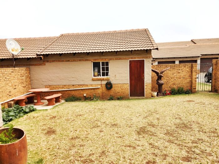 For Sale: Noordwyk Townhouse with 3 bedrooms, double garage, and enclosed yard.