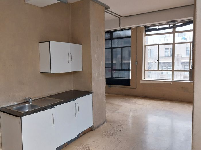 For Sale: Bachelor apartment in Johannesburg Central, 24-hour security, rental income potential.