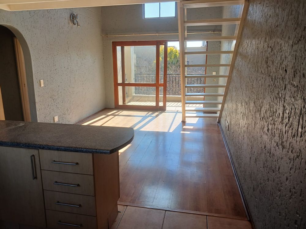 Kitchen with under counter oven, glass hob, extractor fan, one appliance and fridge space