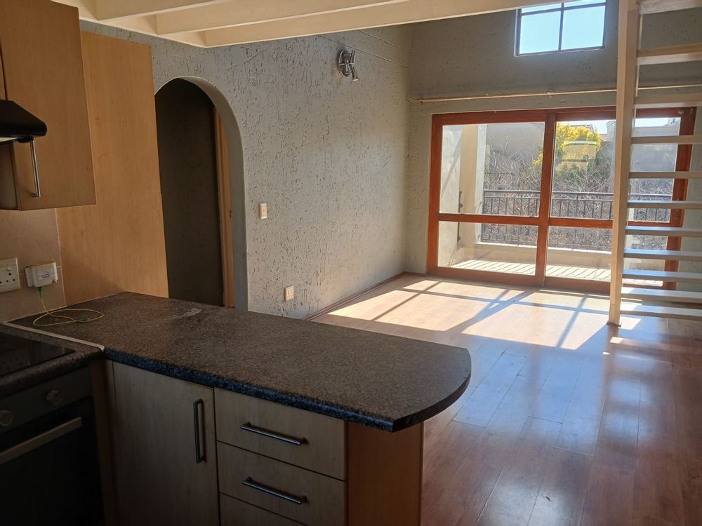 View from kitchen of lounge, dining room and sliders to patio