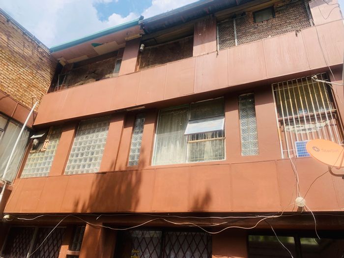 For Sale: House in Bezuidenhout Valley with church, 13 apartments, and rental income.