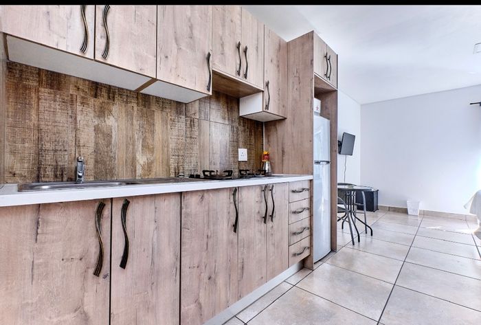 Woodmead Apartment To Rent: Furnished bachelor unit with patio and pool access.