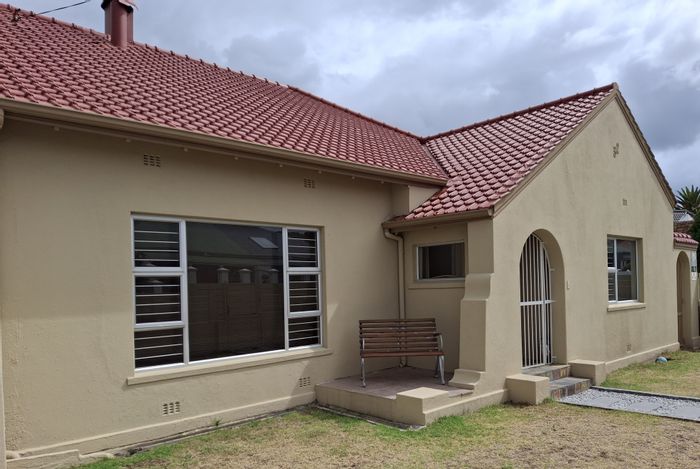 House For Sale in Strand North: 4 beds, income flatlet, steps from beach.