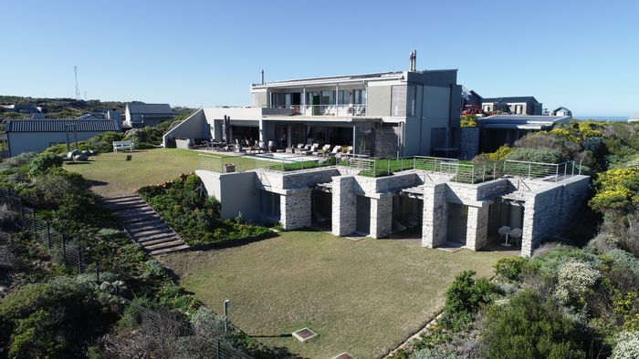 Beachfront house in Romansbaai Estate for sale, featuring 6 en-suites and gym.