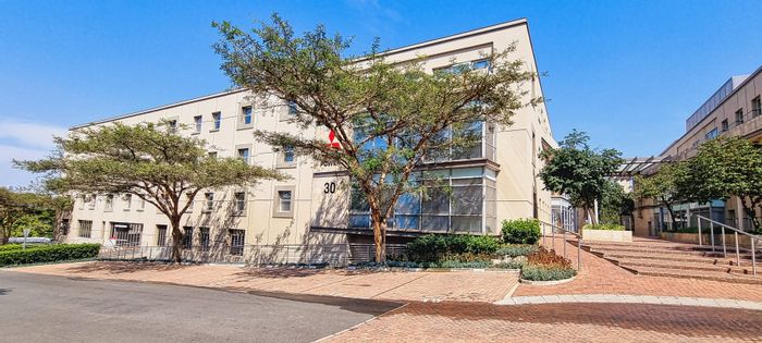 Woodmead Office To Rent: White boxed, dual entrances, shared patio, and ample amenities.