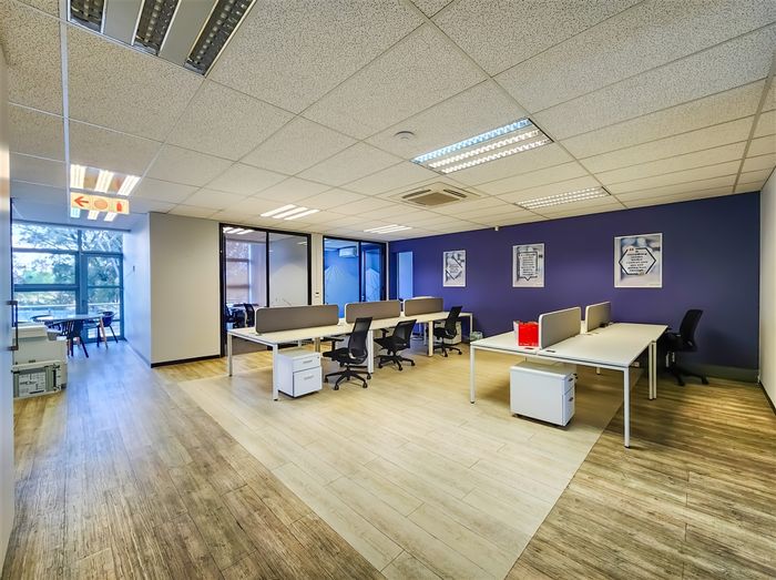 Fourways Office To Rent: Open-plan workspace, private offices, shared balcony, 24-hour security.