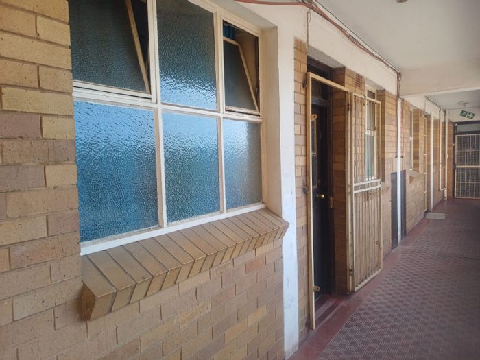 For Sale: 2-Bedroom Flat in Krugersdorp Central with secure parking and balcony.