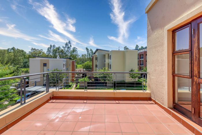 For Sale: Apartment in Douglasdale with clubhouse, pool, tennis court, and balcony.