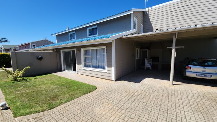 For Sale: Townhouse in Hartenbos Central with pool, carport, and outdoor shower.