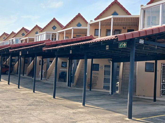 Uvongo Apartment For Sale: Steps to beach, private patio, pool, and braai areas.