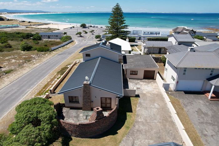 For Sale: Spacious 6-bedroom house in Struisbaai Central, near beach and shops.