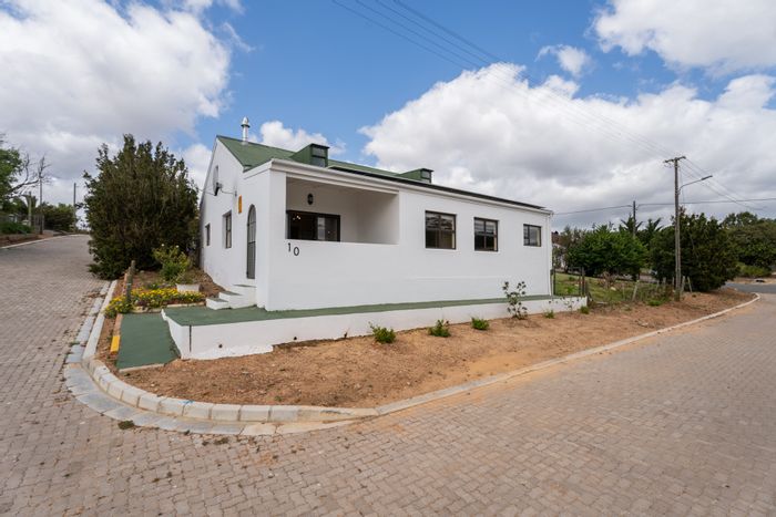 Napier Central House For Sale: Renovated cottage with solar, garden, and versatile loft.