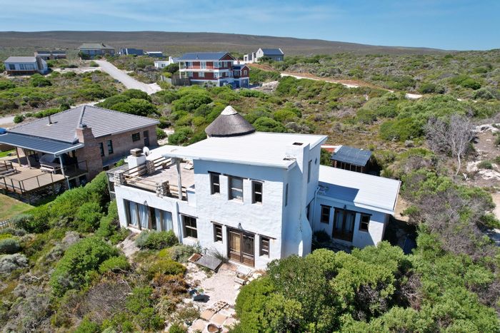 For Sale: House in Suiderstrand Central with open-plan living, balcony, and braai area.