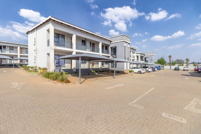 Witpoortjie Apartment For Sale: Open-plan living, pool, security, and parking included.