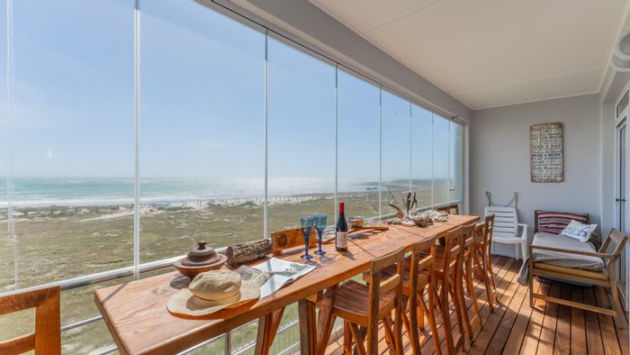 For Sale: Ocean-view 3-bedroom apartment in Struisbaai Central, secure complex, garage included.