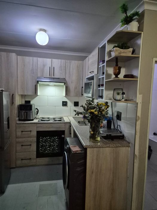 2-Bedroom Apartment For Sale in Commercia with open-plan kitchen and carport.