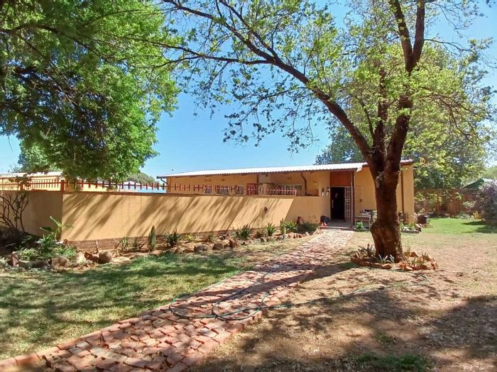 For Sale: House in Sasolburg Ext 15 with spacious yard, open plan living, and garage.