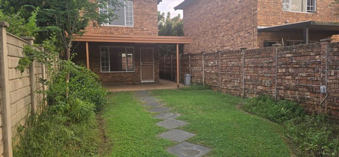 For Sale: 2-Bedroom Townhouse in Annlin with security, garages, and pet-friendly garden.