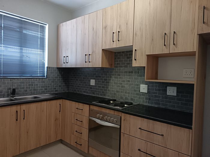 Two-bedroom flat in St Georges Park with balcony, garage parking, and amenities nearby.