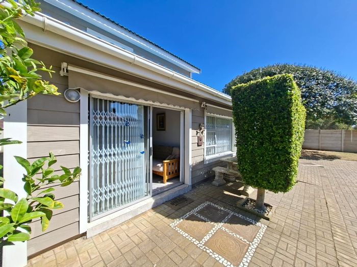 For Sale: Hartenbos Central Townhouse with double garage, pool access, and private lawn.