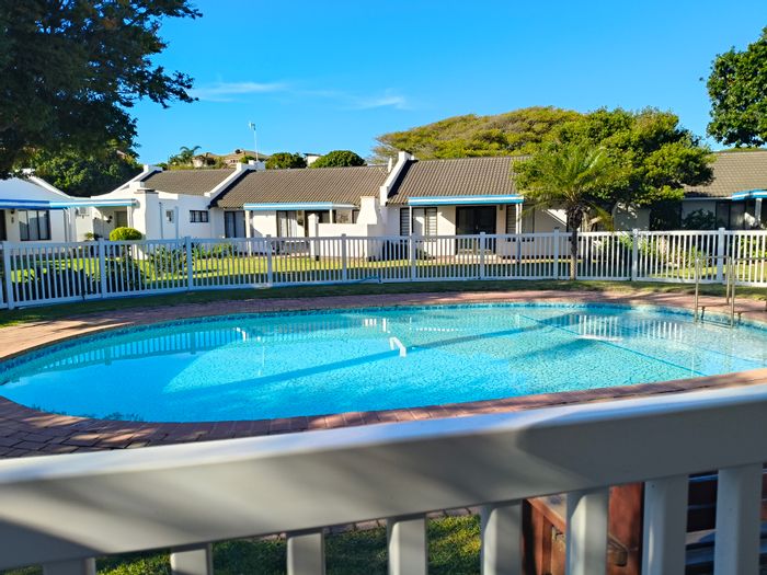 For Sale: Townhouse in Paradise Beach with patio, communal pool, and beach access.