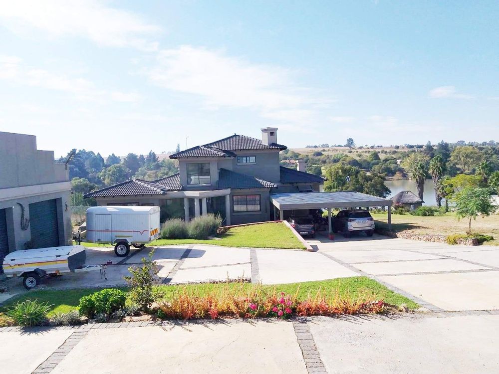 Garages, main house & carport with river