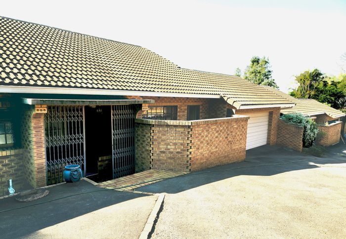 For Sale: Spacious Wembley Townhouse with double garage, deck, and garden views.