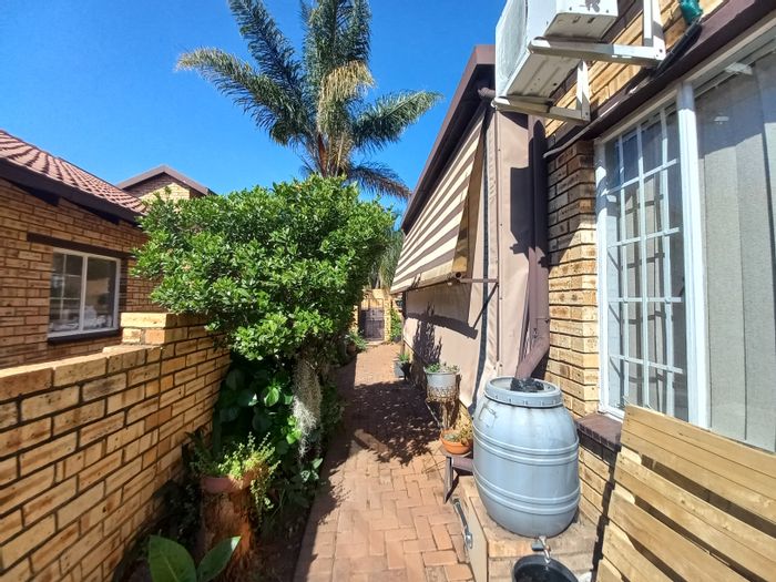 For Sale: Townhouse in Safari Gardens with pools, fishing pond, and rainwater tanks.