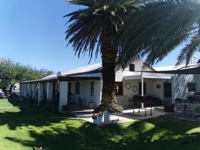 Merweville Farm For Sale: 43 hectares, pomegranate irrigation, multiple boreholes, spacious dwelling.