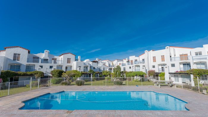For Sale: Apartment in Struisbaai Central with pool, garden access, and dual living spaces.
