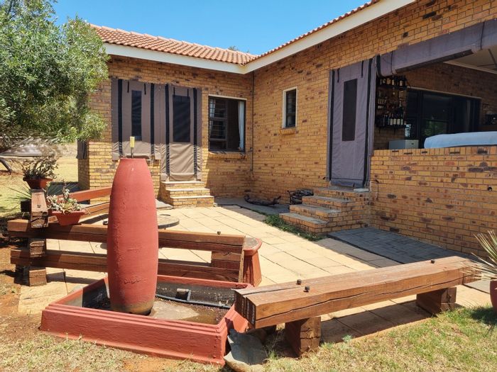 For Sale: House in Buffelspoort Eco Estate with garden, mountain views, and trails.