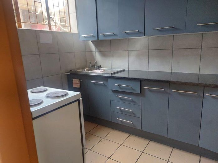 For Sale: 3-Bedroom Apartment in Rustenburg Central with upgraded kitchen and nearby shops.