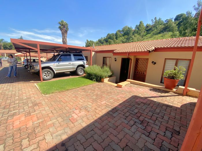 For Sale: Townhouse in Roodekrans with private garden, secure parking, and easy access.