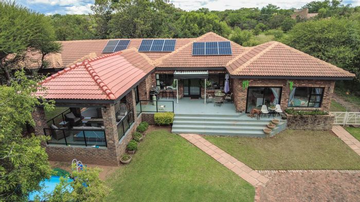 For Sale: House in Pebble Rock Golf Village with 4 beds, solar system, and greenhouse.