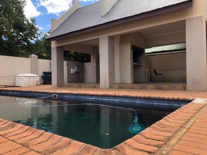 Die Bult Apartment For Sale: Open plan living, pool, secure parking, and communal braai.