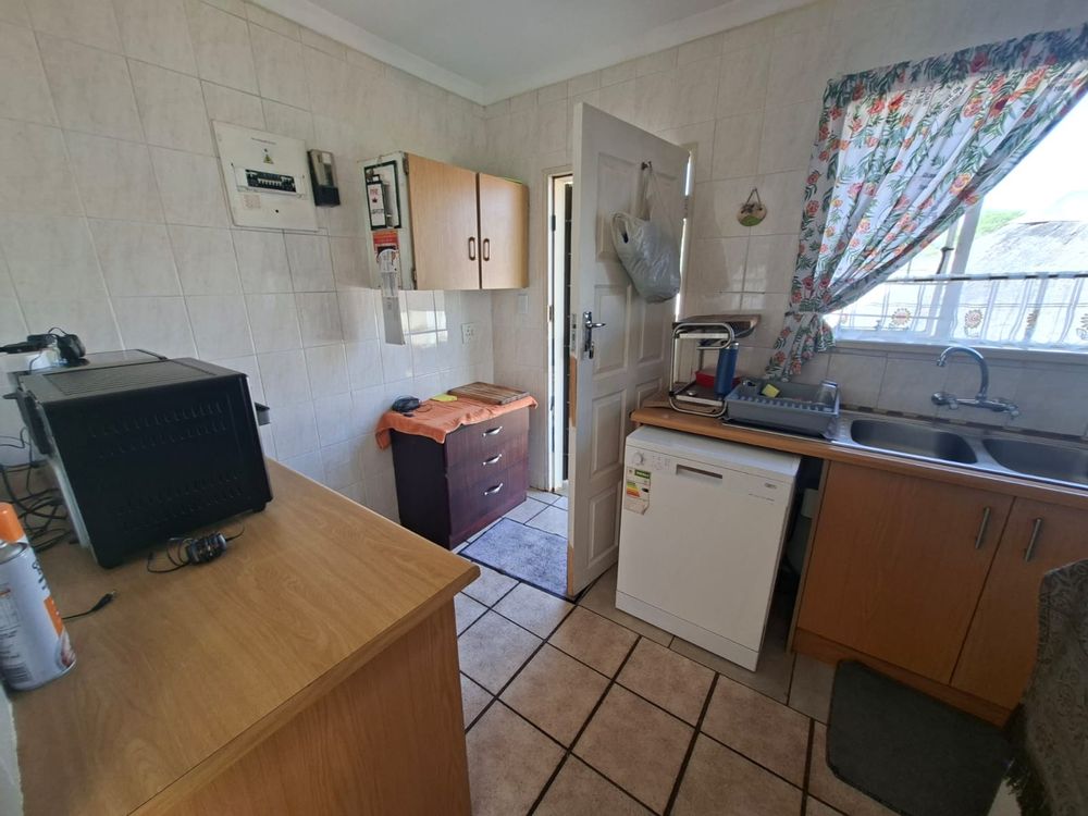 Scullery with back door leading to outside lapa