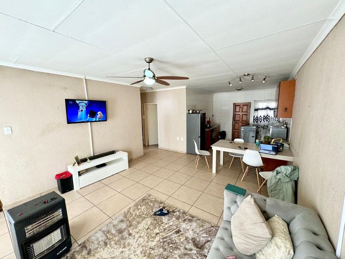 For Sale: Secunda Central Townhouse with 2 bedrooms, garage, security, and communal play area.