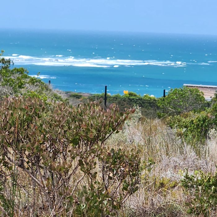 For Sale: Coastal house in Stilbaai Wes with ocean views, braai areas, and garden.