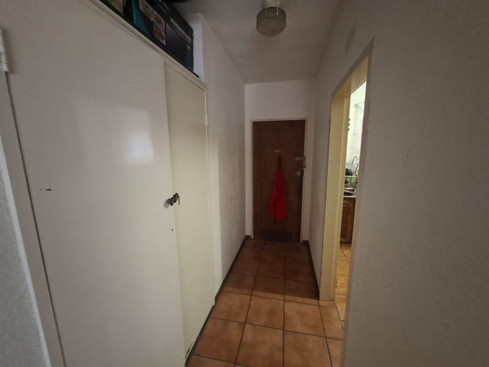 Front door and linen cupboard left